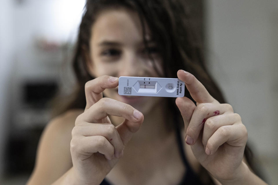 Ariel Kahana, 10, shows her COVID-19 antigen test result ahead of the first day of school in Moshav Talmey Yafe, Israel, Aug. 31, 2021. / Credit: Tsafrir Abayov / AP