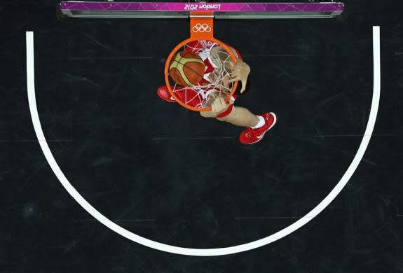 Russia's Sergey Karasev dunks against Brazil during the men's preliminary round Group B basketball match at the Basketball Arena during the London 2012 Olympic Games August 2, 2012.