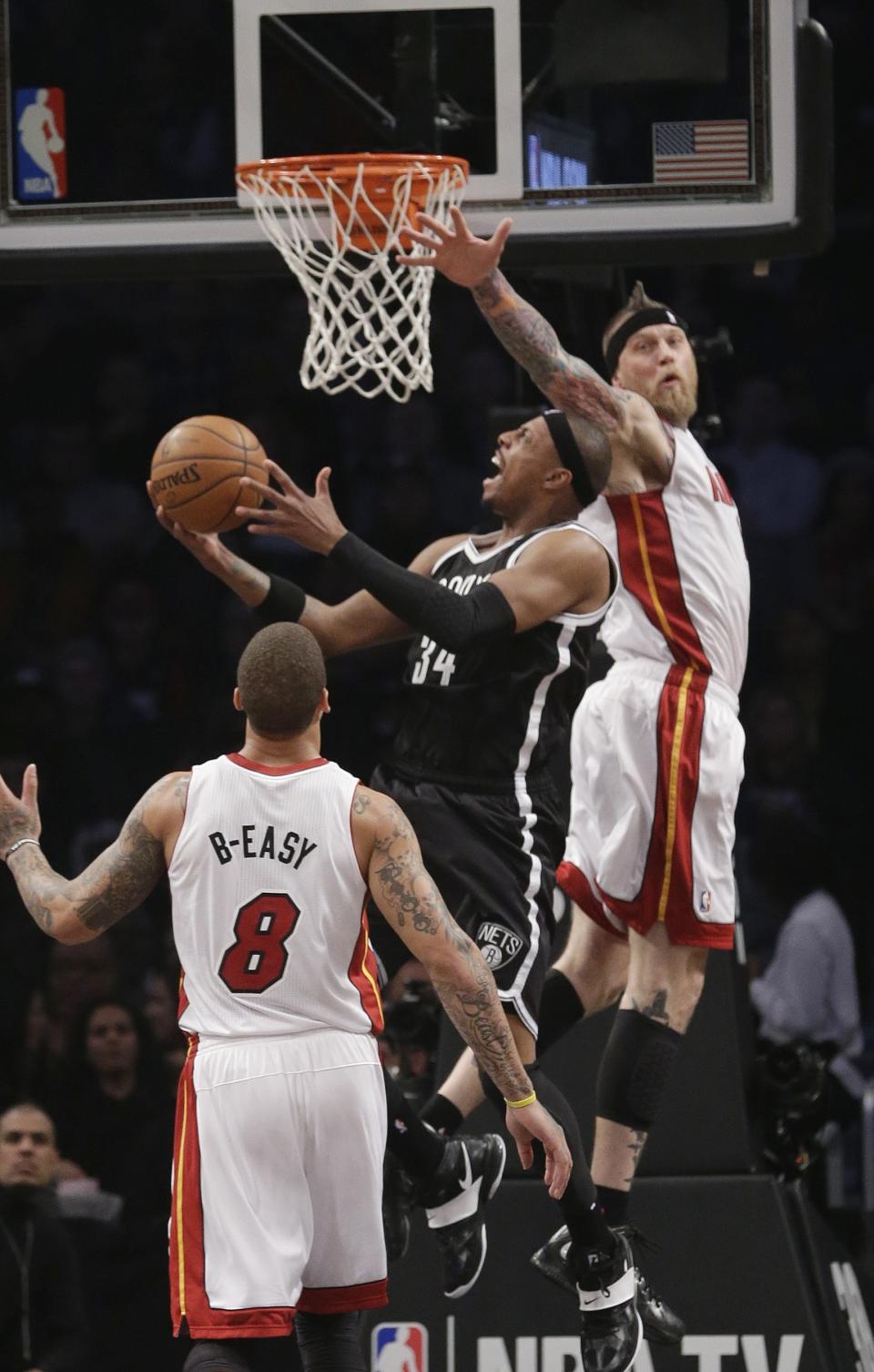 Brooklyn Nets' Paul Pierce (34) drives past Miami Heat's Chris Andersen (11) during the first half of an NBA basketball game on Friday, Jan. 10, 2014, in New York. (AP Photo/Frank Franklin II)