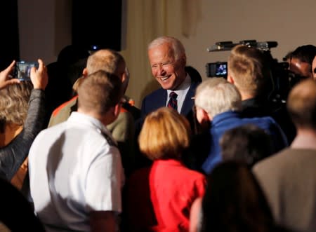 FILE PHOTO: Democratic 2020 U.S. presidential candidate and former Vice President Joe Biden laughs as he talks with potential supporters at a campaign town hall meeting in Rochester