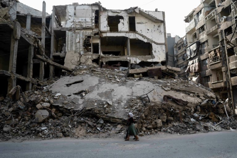 Syrian girls walk past destroyed buildings in the rebel-held town of Douma, on the eastern outskirts of Damascus, on May 6, 2017