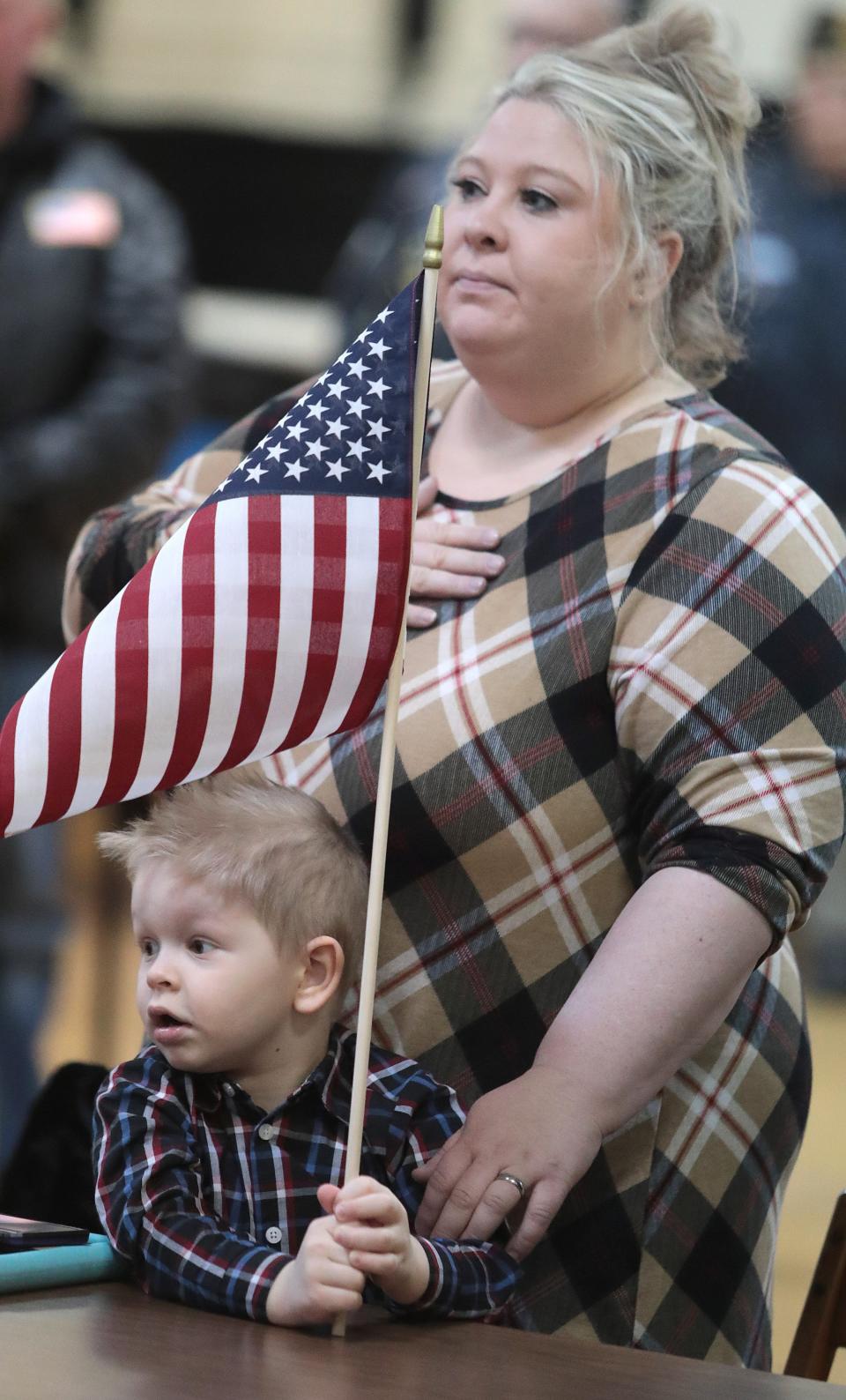 Brittany Snee and her son Micha Snee, 3, stand for the color guard at American Legion Post No. 221 in Massillon at an event honoring the late Army Sgt. Vernon Judd of Sugar Creek Township, a Korean War POW who died in North Korea in 1951. His remains were returned in 2019.