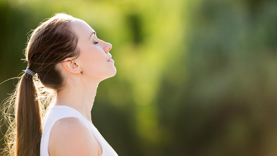 A woman doing a silent meditation to calm her nervous system