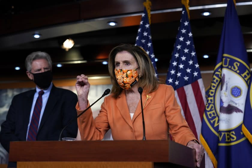 Rep. Frank Pallone, D-N.J., left, listens as Speaker of the House Nancy Pelosi, D-Calif., speaks with reporters at the Capitol in Washington, Thursday, Oct. 8, 2020. Negotiations between Pelosi and Treasury Secretary Steven Mnuchin for an additional coronavirus aid package were abruptly halted last week by President Donald Trump. (AP Photo/J. Scott Applewhite)