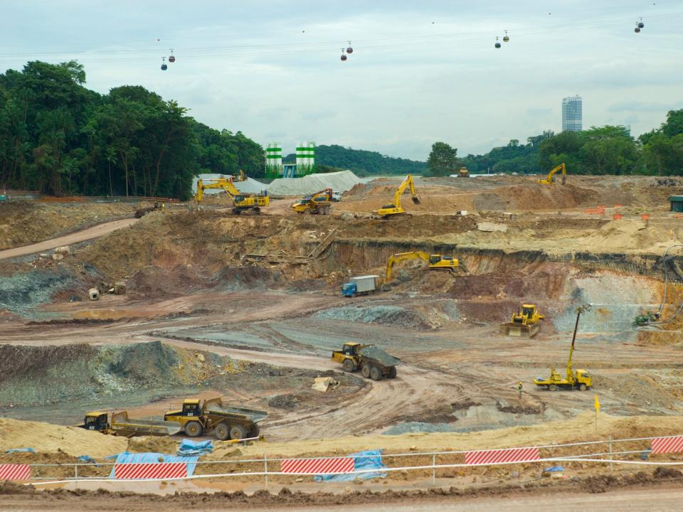 Construction crews work to complete a new resort area on Sentosa Island.