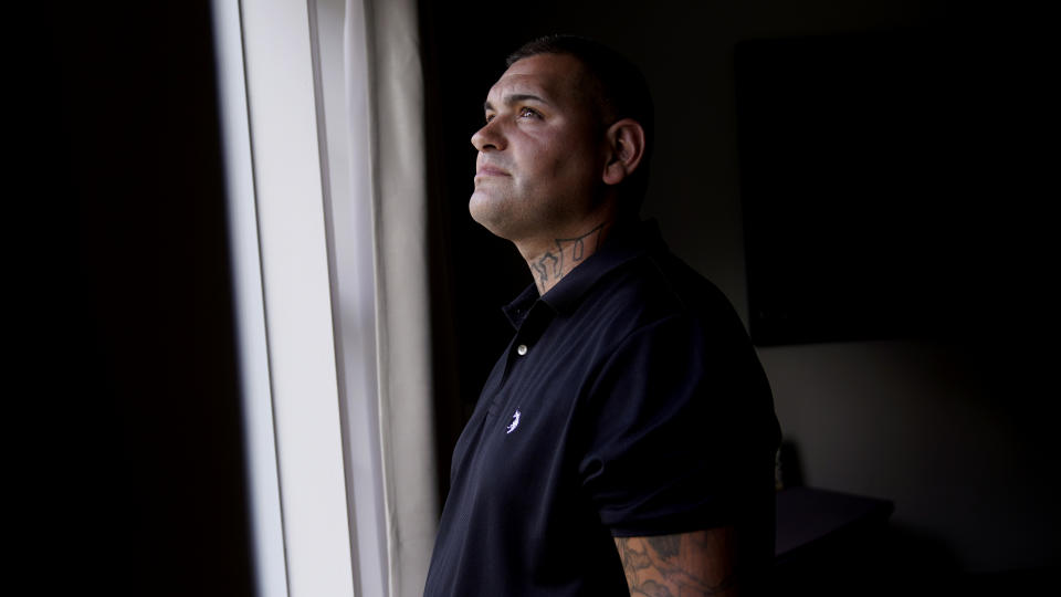 Mike Gilpatrick, who as a teenager was incarcerated at the Youth Development Center, waits for his children to return from school at their home, Wednesday, Sept. 8, 2021, in Nashua, N.H. Gilpatrick, 38, filed a lawsuit Monday Sept. 13, alleging he was physically and sexually abused at the former YDC in Manchester, which has been the target of a criminal investigation since 2019 and is slated to close in 2023. (AP Photo/Charles Krupa)