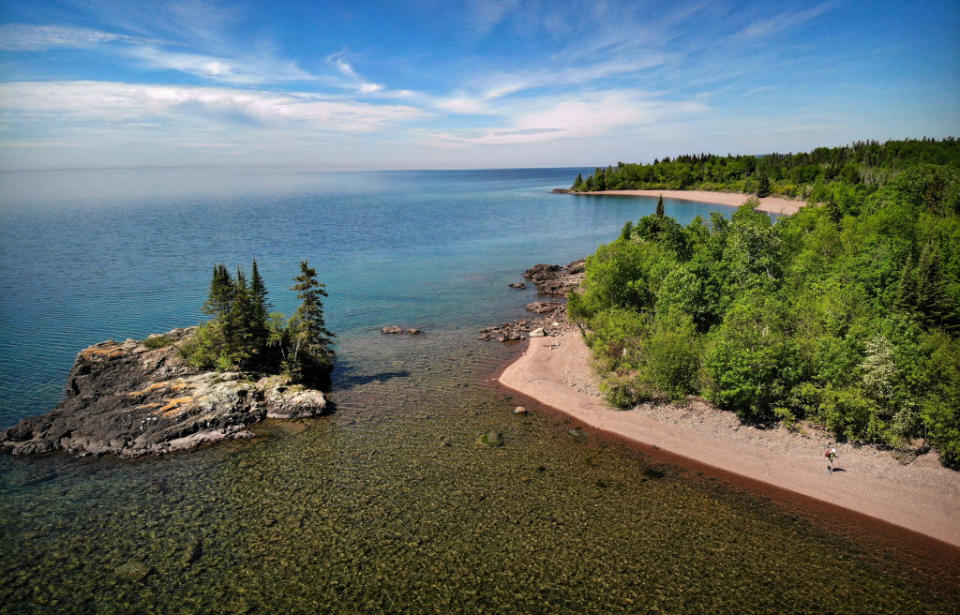 The 1.6 mile Cakewalk north of Grand Marais is the only section of trail that runs along the shore of Lake Superior outside of the Duluth Lake Walk. Here, Melanie McManus hikes the rocky shore of Lake Superior past the Tombolo Island.<span class="copyright">Brian Peterson-Star Tribune/Getty Images</span>