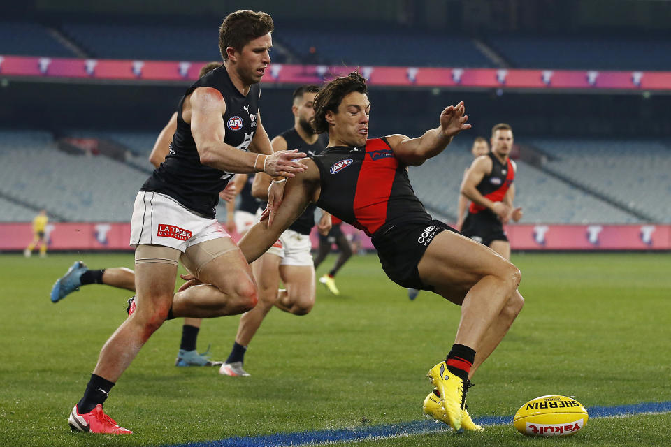 Dylan Shiel kicks the ball under pressure from Marc Murphy.