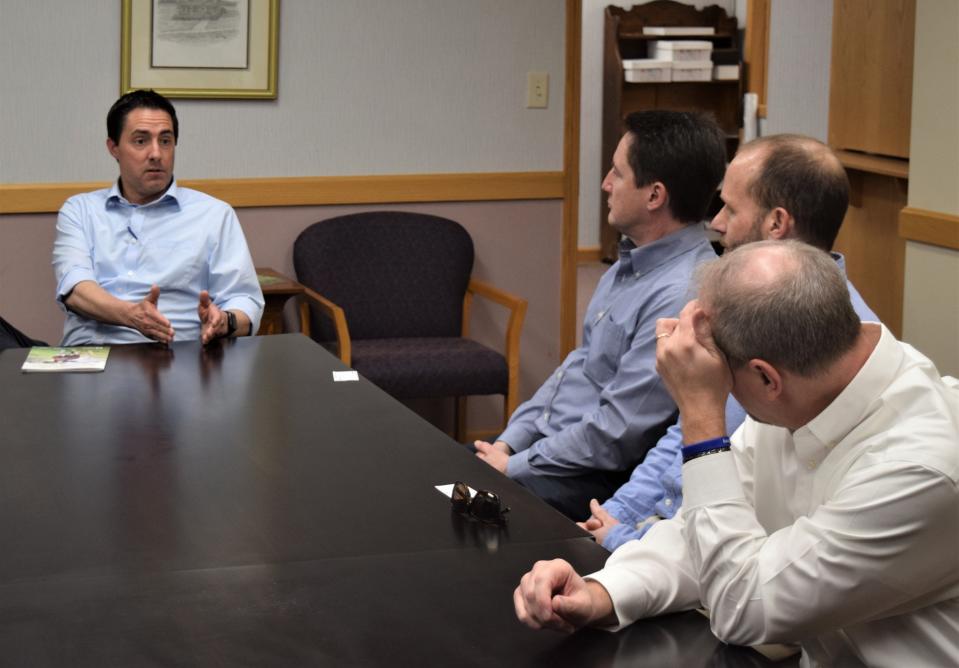 Ohio Secretary of State Frank LaRose (left) talks about business with Jay McCulloch, Mark Leininger and Jason Hummel.