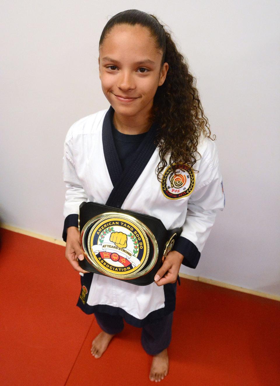 Aris Roane, 12, of Brooklyn, with the belt she won as the Tang Soo Do Grand Champion competing against adults recently.