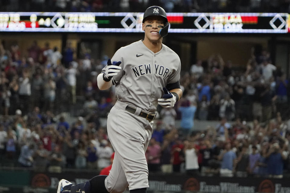 FILE - New York Yankees' Aaron Judge gestures as he runs the bases after hitting a solo home run, his 62nd of the season, during the first inning in the second baseball game of a doubleheader against the Texas Rangers in Arlington, Texas, Tuesday, Oct. 4, 2022. With the home run, Judge set the AL record for home runs in a season, passing Roger Maris. Judge won the American League MVP Award on Thursday, Nov. 17, 2022, in voting by a Baseball Writers' Association of America panel. (AP Photo/LM Otero, File)