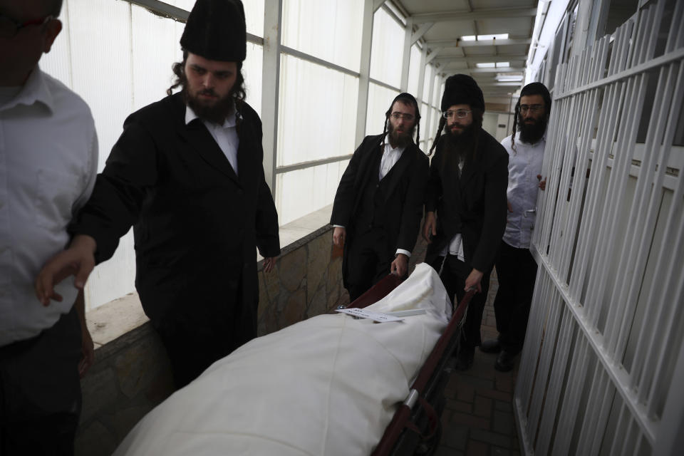 The body of Eliyahu Kay, a 26-year-old immigrant to Israel from South Africa, is carried during his funeral the day after he was killed when a Palestinian man opened fire in the Old City of Jerusalem, Monday, Nov. 22, 2021, in Jerusalem. (AP Photo/Oded Balilty)