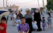 Syrians flee the town of Aazaz, near the northern restive Syrian city of Aleppo, following an air strike on the town