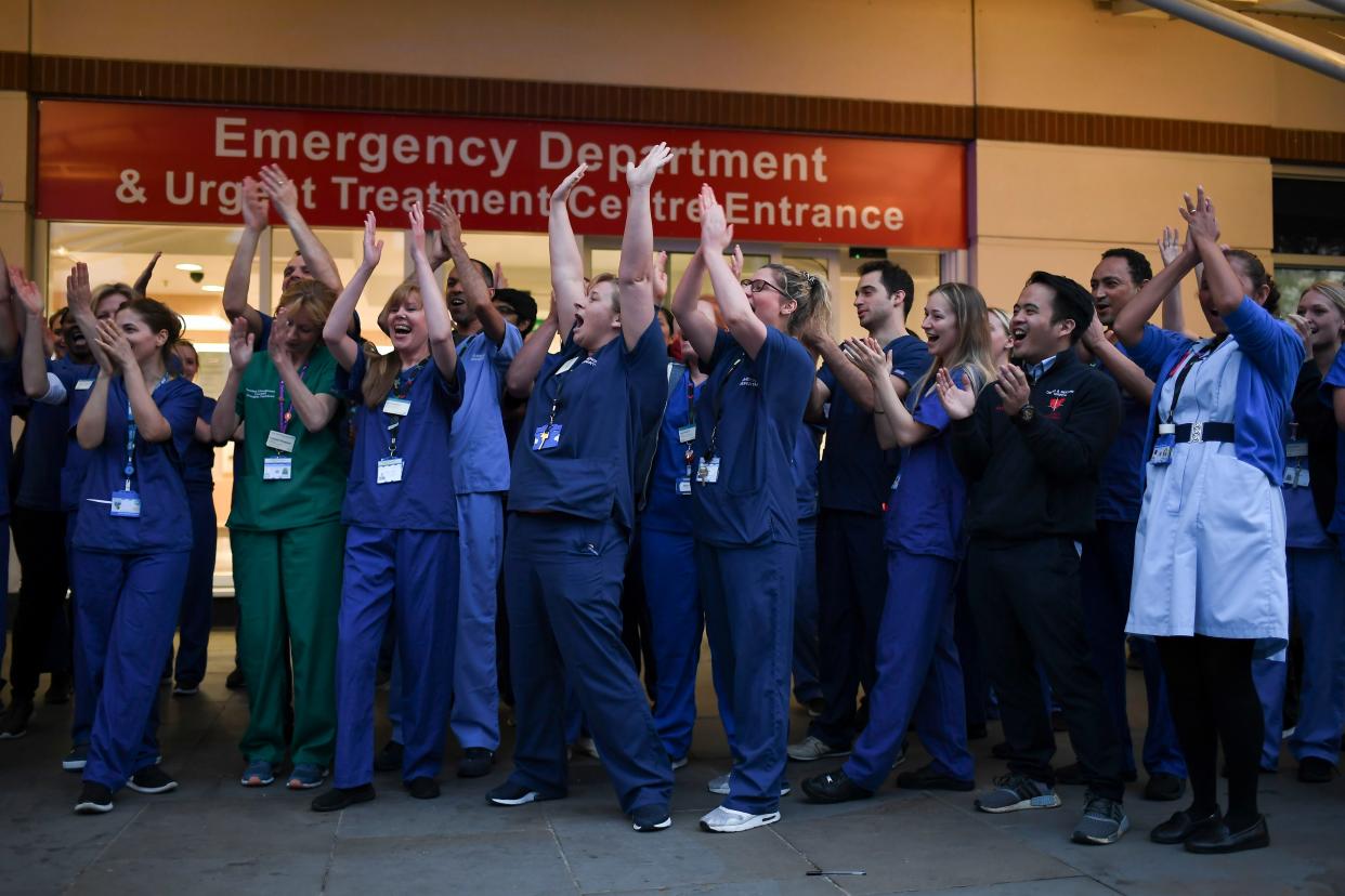 NHS staff applaud outside the Chelsea and Westminster Hospital in London during the weekly "Clap for our Carers", Thursday, April 16, 2020. The applause takes place across Britain every Thursday at 8pm local time to show appreciation for healthcare workers, emergency services, armed services, delivery drivers, shop workers, teachers, waste collectors, manufacturers, postal workers, cleaners, vets, engineers and all those helping people with coronavirus and keeping the country functioning while most people stay at home in the lockdown.