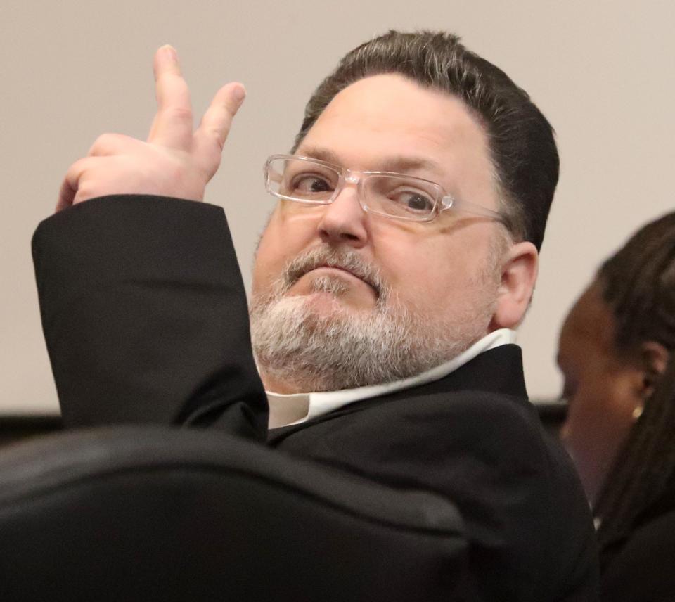 Robert Remus Jr. gestures to family members, Friday, June 2, 2023, as he goes on trial for killing his father, Robert Remus Sr., in 2012 while on a boat on the St. Johns River.