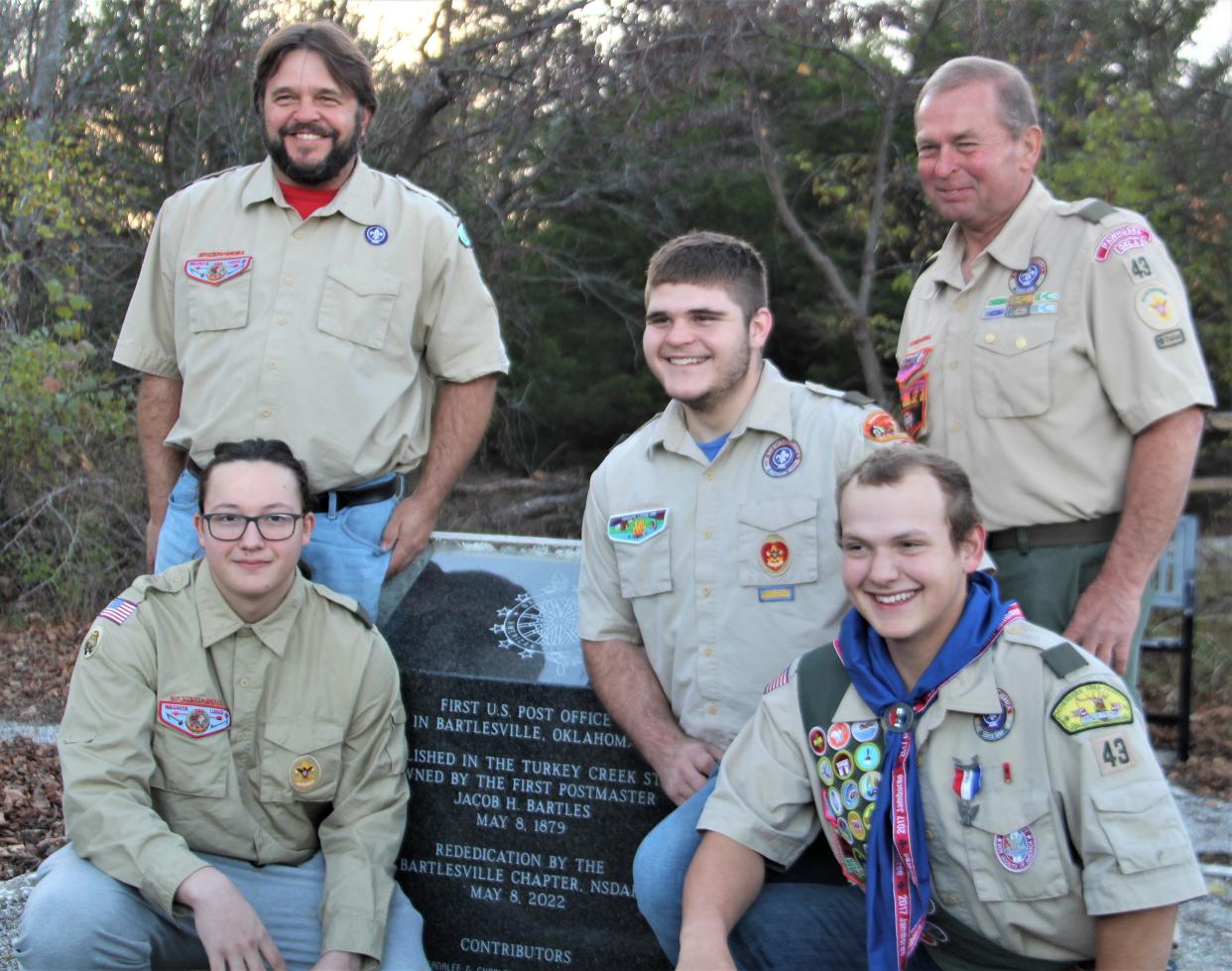 Boy Scouts Levi Holley (left), Kameron Long (center) and Samuel Myers (right) are shown in the foreground of this image. Their scout leaders, Adam Long, at left, and Bruce Hendren, at right, are shown standing behind them.