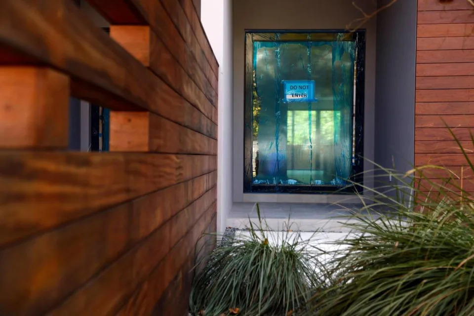 A ‘Do Not Enter’ sign is affixed to the front door of one of the 12 luxury townhouses on Coconut Avenue in Coconut Grove that have been built by Doug Cox of Drive Development. Buyers of the homes have been waiting years to move in.