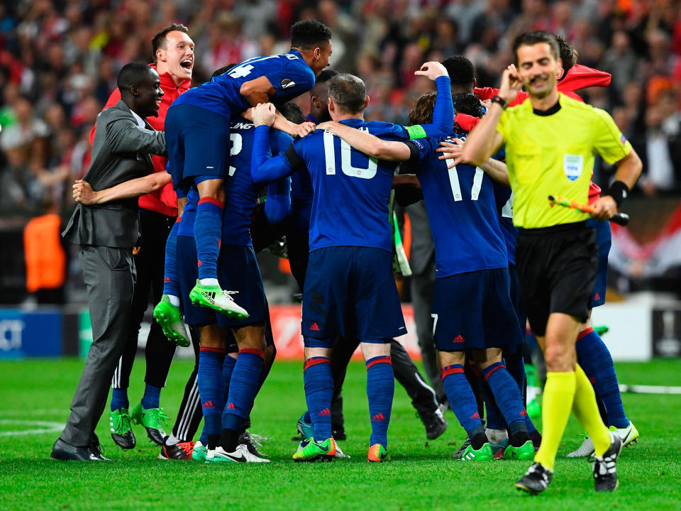 Manchester United celebrate after the final whistle: Getty