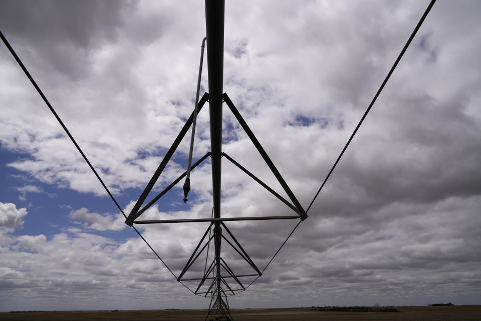 A pivot irrigation system stands on Steve Hanson's corn field following a heavy rain Saturday, April 30, 2022, in Elsie, Neb. He raises beef cattle and grows corn, all of his irrigated water coming from the Ogallala Aquifer. (AP Photo/Brittany Peterson)