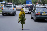 A disabled girl begs in Kabul, Afghanistan, Sunday, May 22, 2022. Some 1.1 million Afghan children under the age of five will face malnutrition by the end of the year. , as hospitals wards are already packed with sick children . (AP Photo/Ebrahim Noroozi)