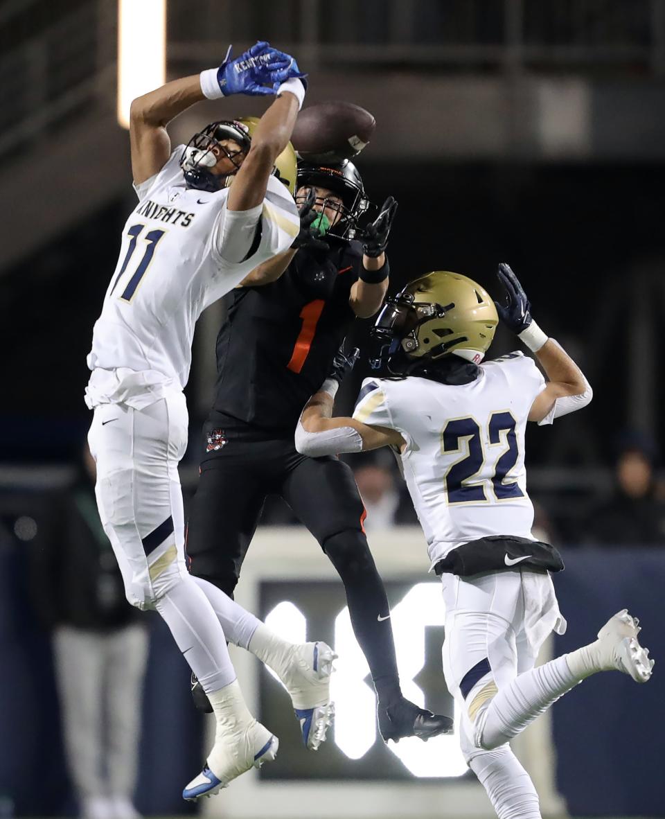 Hoban defensive back Elbert Hill IV, left, tips a pass intended for Massillon wide receiver Braylyn Toles, center, during the second half.