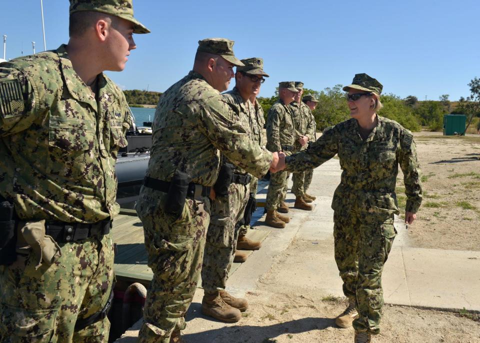 FILE: Service members from Coast Guard Port Security Unit 311, deployed to Naval Station Guantanamo Bay, Cuba, greet Vice Adm. Linda Fagan, commander Pacific Area, during Fagan's visit, Dec. 14, 2018. (Photo edited for security) / Credit: Provided by U.S. Coast Guard