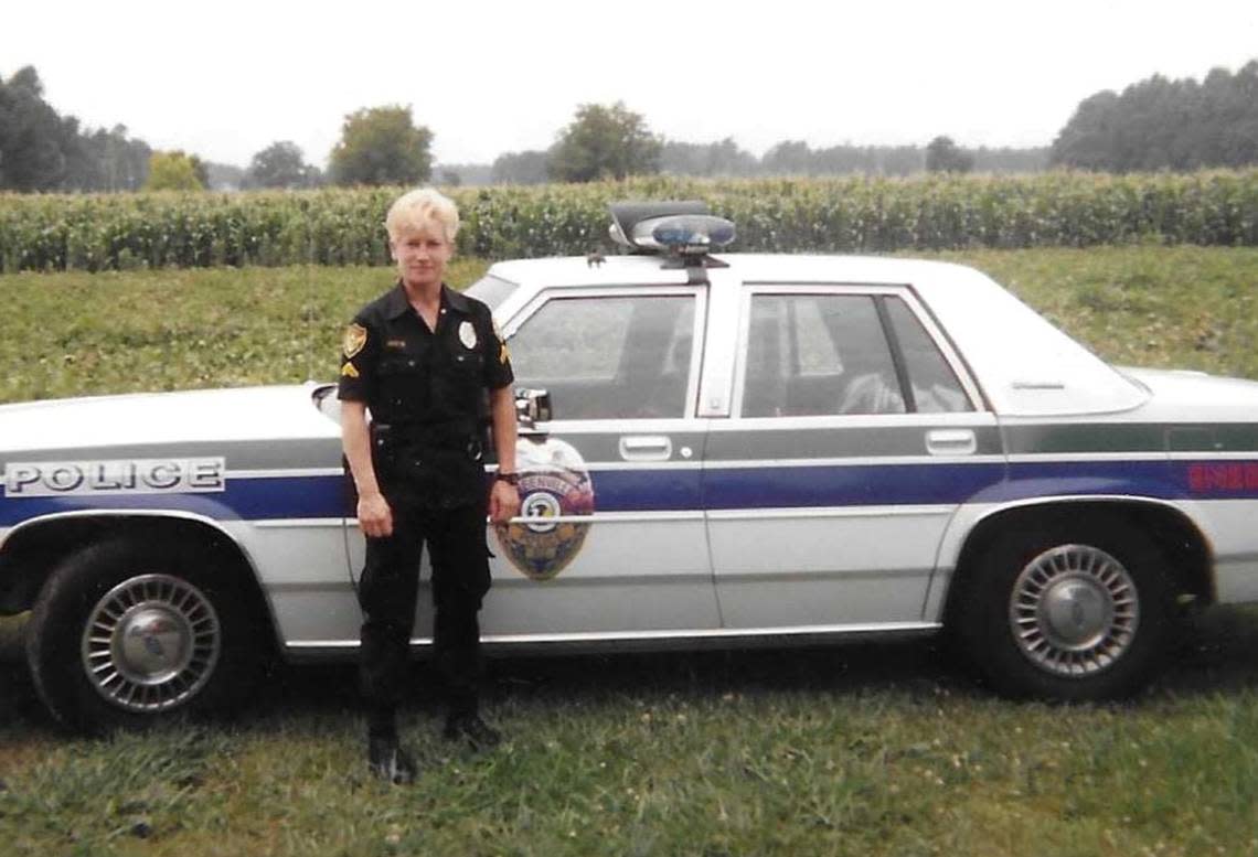 Maria Jocys alongside her Greenville Police Department patrol vehicle.