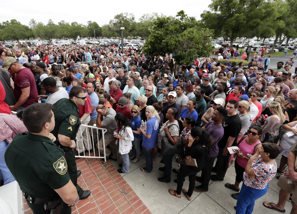 <p>Parents and relatives gather to pick up students at the First Baptist Church of Ocala after a shooting incident at nearby Forest High School, Friday, April 20, 2018, in Ocala, Fla. (Photo: John Raoux/AP) </p>