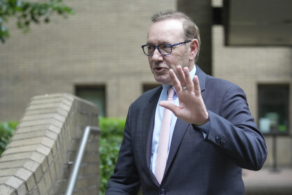 Actor Kevin Spacey waves to the media as he leaves Southwark Crown Court in London, Wednesday, June 28, 2023. Spacey is going on trial on charges he sexually assaulted four men as long as two decades ago. The double-Oscar winner faces a dozen charges as his trial begins Wednesday at Southwark Crown Court. Spacey pleads not guilty to all charges . (AP Photo/Kin Cheung)