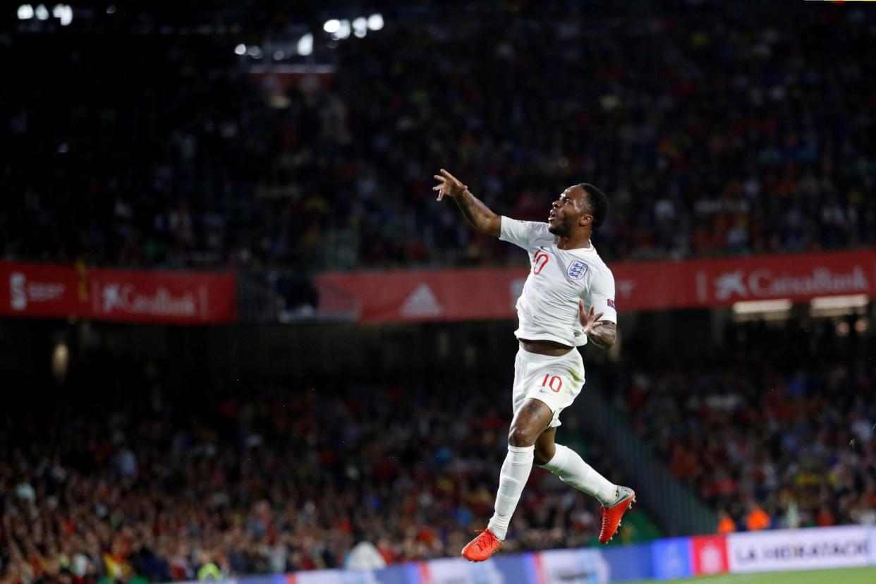 Superb finish: Sterling celebrates after lashing home to put England in front: Action Images via Reuters