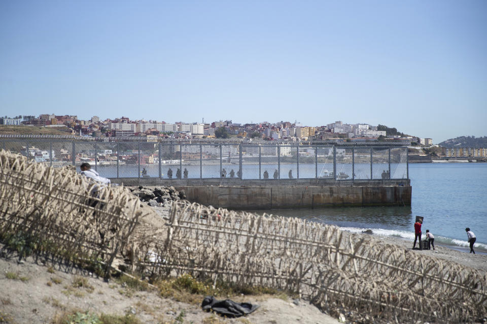 Spanish security forces stand guard at the border of the Spanish enclave of Ceuta, on Wednesday, May 19, 2021. Spain’s north African enclave of Ceuta has awakened to a humanitarian crisis after thousands of migrants who crossed over from Morocco spent the night sleeping where they could find shelter. (AP Photo/Mosa'ab Elshamy)