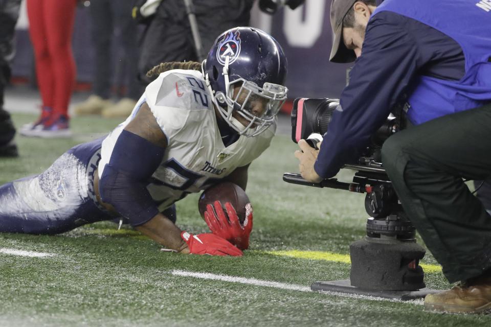 A cameraman focuses on Tennessee Titans running back Derrick Henry, after he landed out of bounds following a run in the first half of an NFL wild-card playoff football game against the New England Patriots, Saturday, Jan. 4, 2020, in Foxborough, Mass. (AP Photo/Steven Senne)