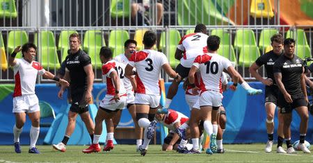 2016 Rio Olympics - Rugby - Preliminary - Men's Pool C New Zealand v Japan - Deodoro Stadium - Rio de Janeiro, Brazil - 09/08/2016. Japan celebrates after defeating New Zealand. REUTERS/Alessandro Bianchi