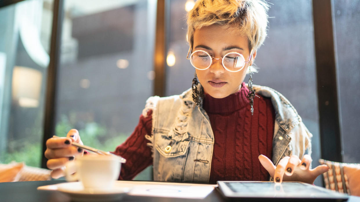 Latin woman checking some graphics from digital investment.