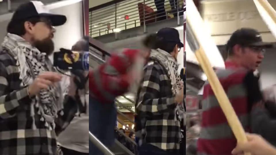 So much for a peaceful protest: Tim Joseph was flattened by the man in the red sweater as he spoke to a crowd of Ohio State University students.