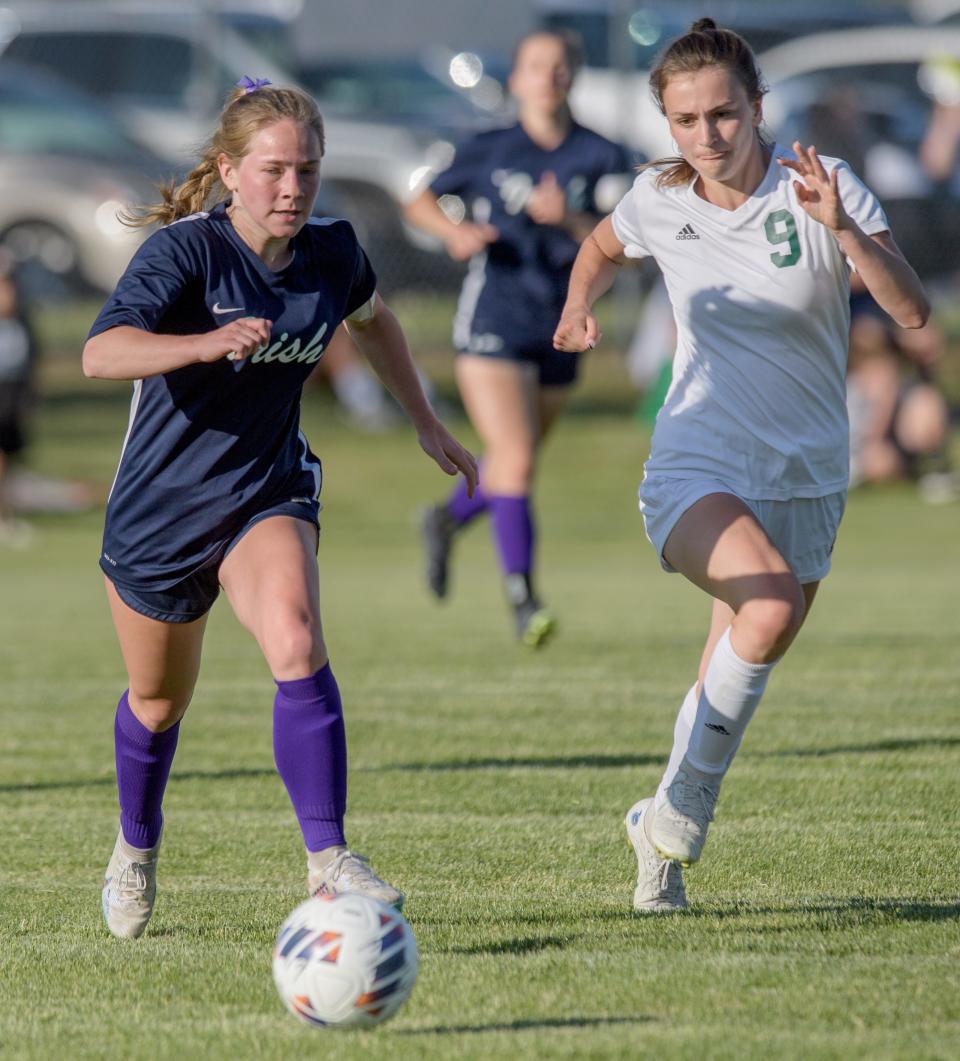 Peoria Notre Dame's Ellen Dahlquist, left, moves the ball against Geneseo's Katlyn Seaman in the first half of the Class 2A Dunlap Sectional soccer match Friday, May 26, 2023 at Dunlap Valley Middle School. The Irish advanced to the super-sectional with a 4-0 win.
