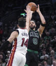 Boston Celtics forward Jayson Tatum (0) shoots over Miami Heat guard Tyler Herro (14) during the first half of Game 5 of an NBA basketball first-round playoff series, Wednesday, May 1, 2024, in Boston. (AP Photo/Charles Krupa)