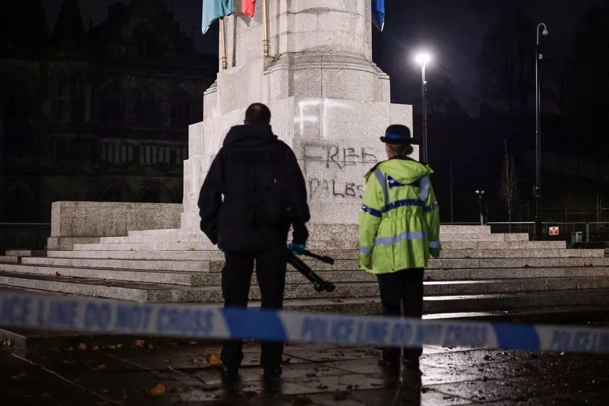 Police stood guard at the memorial following its defacing. (Reach)
