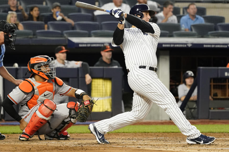 New York Yankees' Anthony Rizzo watches the ball after hitting a solo home run in the fourth inning of a baseball game against the Baltimore Orioles, Wednesday, Aug. 4, 2021, in New York. (AP Photo/Mary Altaffer)