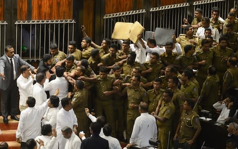 Sri Lankan police try to take their positions to escort parliament speaker Karu Jayasuriya into the assembly hall - Credit: LAKRUWAN WANNIARACHCHI/AFP/Getty Images