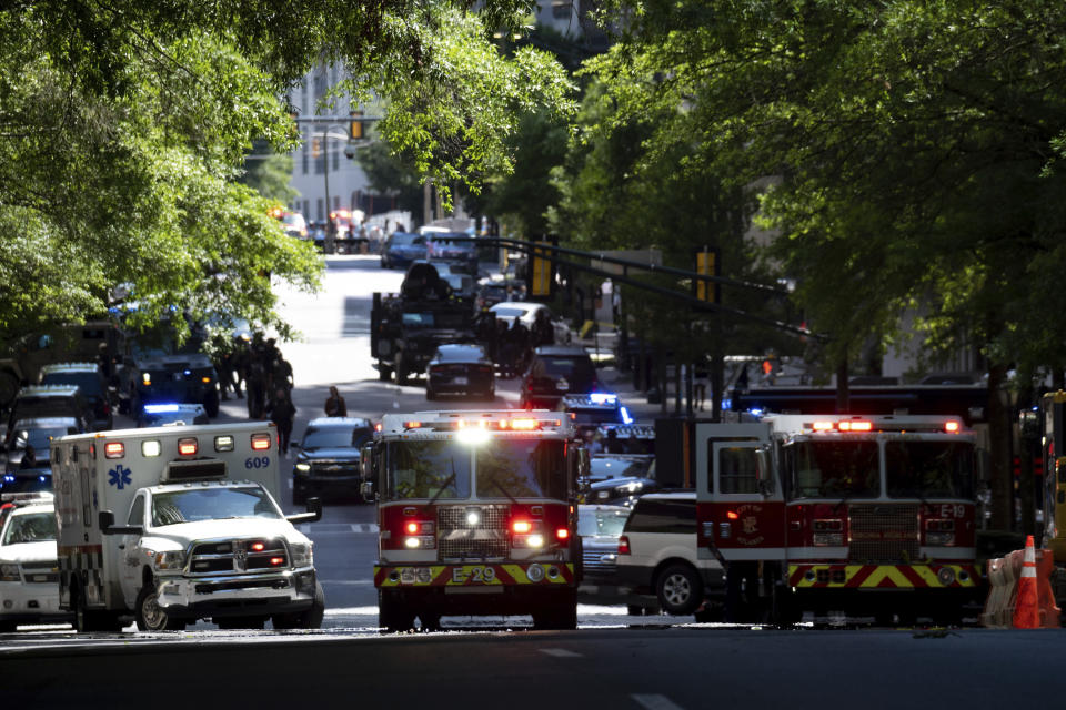 Police and emergency workers gather in Atlanta on Wednesday, May 3, 2023. Police say a shooter opened fire inside the Northside Medical building. (AP Photo/Ben Gray)
