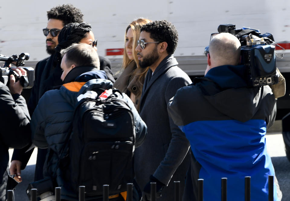 "Empire" actor Jussie Smollett, center, arrives at Leighton Criminal Court Building for a hearing to discuss whether cameras will be allowed in the courtroom during his disorderly conduct case on Tuesday, March 12, 2019, in Chicago. A grand jury indicted Smollett last week on 16 felony counts accusing him of lying to the police about being the victim of a racist and homophobic attack by two masked men in downtown Chicago.(AP Photo/Matt Marton)