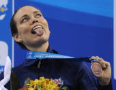 US swimmer Natalie Coughlin sticks her tongue out as she holds her bronze medal on the podium during the award ceremony for the women's 100-metre backstroke swimming event in the FINA World Championships at the indoor stadium of the Oriental Sports Center in Shanghai on July 26, 2011. AFP PHOTO / PETER PARKS (Photo credit should read PETER PARKS/AFP/Getty Images)