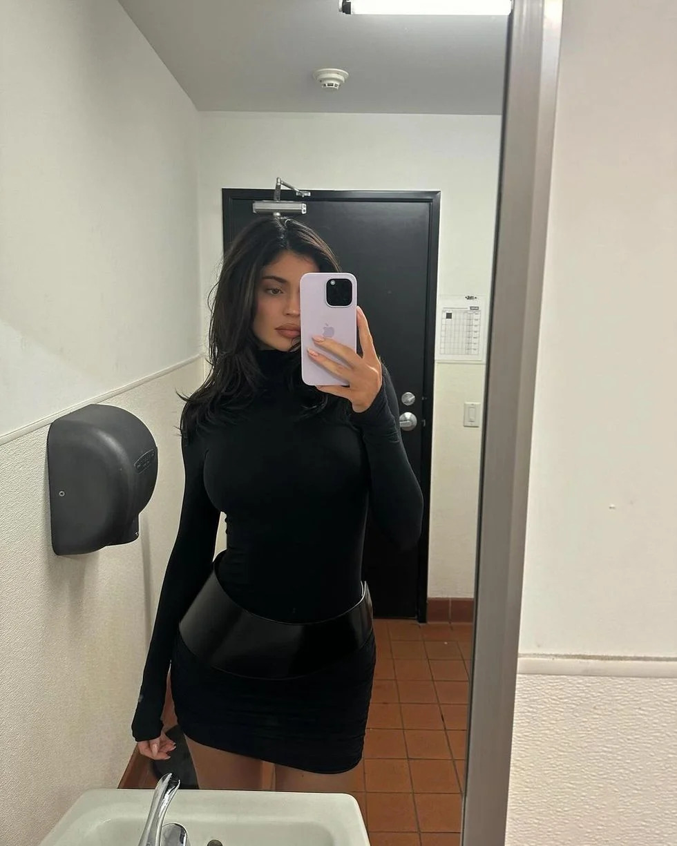 a woman taking a selfie in a bathroom