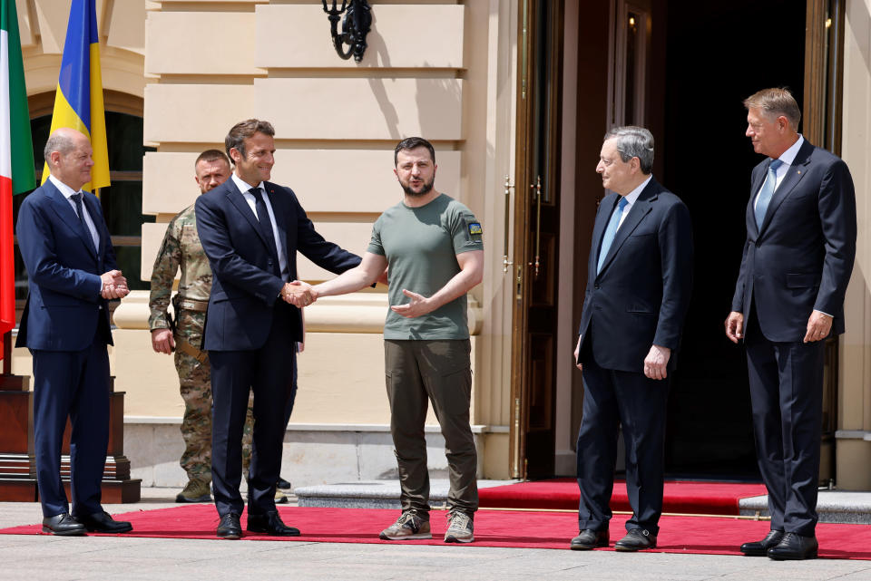 FILE - German Chancellor Olaf Scholz, left, watches Ukrainian President Volodymyr Zelenskyy shakes hands with French President Emmanuel Macron, second left, as Romanian President Klaus Iohannis, right, and Italian Prime Minister Mario Draghi look on before a meeting in Kyiv, Thursday, June 16, 2022. Seven decades after it was founded, the North Atlantic Treaty Organization is meeting in Madrid on June 29 and 30, 2022 with an urgent need to reassert its original mission: preventing Russian aggression against Western allies. (Ludovic Marin, Pool via AP, File)