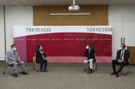 Toshiaki Endo, left, vice president of the Tokyo 2020 Organizing Committee, Seiko Hashimoto, center left, president of the Tokyo 2020 Organizing Committee, Sebastian Coe, center right, president of World Athletics and John Ridgeon, World Athletics CEO, attend a meeting Friday, May 7, 2021 in Tokyo, Japan. Hashimoto said Friday that a planned visit to Japan this month by IOC President Thomas Bach seemed unlikely with a state of emergency order being extended by the government to Tokyo and other areas until May 31.(Carl Court/Pool Photo via AP)