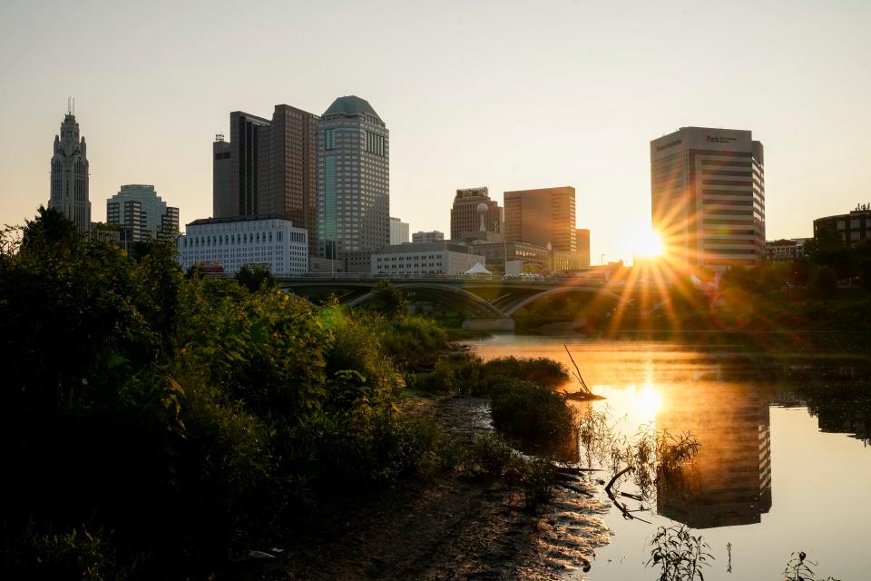 Jul 22, 2023; Columbus, Ohio, USA; The sun rises over the Scioto River and downtown skyline.