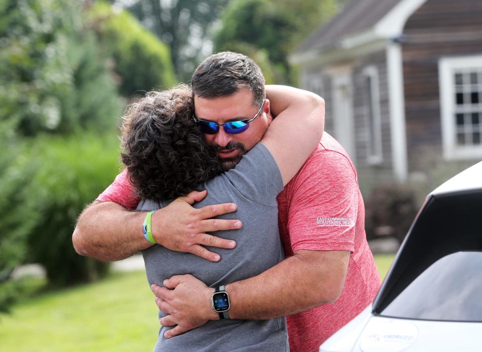 Three-time Super Bowl champion Joe Andruzzi hugs Stratham's Dorothy Roth after he delivered groceries to Roth's father, Rudy Longo on Wednesday, Sept. 13, 2023 in Stratham.