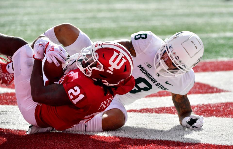 Oct 16, 2021; Bloomington, Indiana, USA;  Indiana Hoosiers defensive back Noah Pierre (21) intercepts a ball intended for Michigan State Spartans wide receiver Jalen Nailor (8) during the second half at Memorial Stadium. Spartans win 20-15.