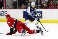 Carolina Hurricanes' Jaccob Slavin (74) leaves his skates to block the shot of Winnipeg Jets' Mark Scheifele (55) during the first period of an NHL hockey game in Raleigh, N.C., Tuesday, Jan. 21, 2020. (AP Photo/Karl B DeBlaker)